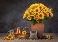 Still life with sunflowers and oil. Seeds in a basket. Concept of harvest Royalty Free Stock Photo