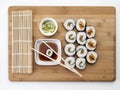 Still life sushi with different makis, sauce, chopsticks and mat Royalty Free Stock Photo