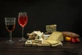 Still life with a table full of delicious assorted cheeses on a board Royalty Free Stock Photo