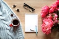 Still life on a table made of light wood. A white Notepad, a Cup of tea,, flowers Royalty Free Stock Photo