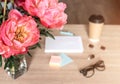 Still life on a table made of light wood. A white Notepad, a Cup of tea,, flowers Royalty Free Stock Photo