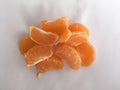 Still life of tangerine slices on a white background. Abstraction.