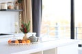 Still life of tangerines, teapot and scales with spruce branch on kitchen table Royalty Free Stock Photo