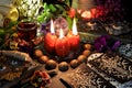 Still life with tarot cards, red candles, magic wand and book of spells on ritual table Royalty Free Stock Photo