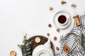 Still life with tea cup and the contents of a workspace composed. Different objects on white table. Flat lay