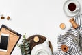 Still life with tea cup and the contents of a workspace composed. Different objects on white table. Flat lay