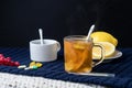 Still life of tea with lemon, tablets and thermometer, jam and berries. The concept of treating colds Royalty Free Stock Photo