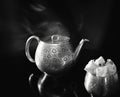 Still life with a teapot and a candy bowl made of polished brass with an oriental ornament. Royalty Free Stock Photo