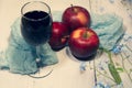 Still-life. Three apples, turquoise fabric and a glass of wine on a light background