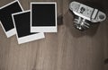 Still life three blank instant photo frames on old wooden background with old retro vintage camera with copy space Royalty Free Stock Photo