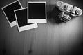 Still life three blank instant photo frames on old wooden background with old retro vintage camera with copy space Royalty Free Stock Photo