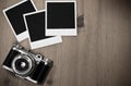 Still life three blank instant photo frames on old wooden background with old retro vintage camera with copy space Royalty Free Stock Photo