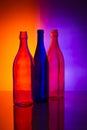 Still life with three bottles against a colored background Royalty Free Stock Photo