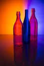 Still life with three bottles against a colored background Royalty Free Stock Photo