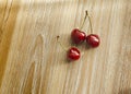 Still life with three red cherries.