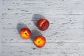 Still life of three ripe appetizing peaches, on a light wooden textured table Royalty Free Stock Photo