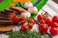 Still life: tomatoes, black bread, garlic, fennel and bayberry Royalty Free Stock Photo