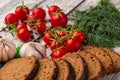 Still life: tomatoes, black bread, garlic, fennel, bayberry Royalty Free Stock Photo