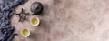 Still life with traditional Asian herbal tea, cooked in an old cast-iron kettle on a textured background. Banner Royalty Free Stock Photo