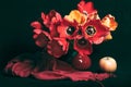 still life with tulips apples and a red scarf on a dark background Royalty Free Stock Photo