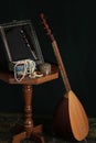 Still life in turkish Muslim ottoman oriental style. Turkish national musical instrument baglama saz, jewelry box and mirror on