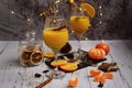 Still life of two glasses with orange juice and slices of tangerines and oranges on the background of New Year`s decor Royalty Free Stock Photo
