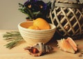 Still life - two lemons in a basket, two sea shells and basket lamp Royalty Free Stock Photo