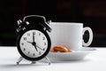 Still life , vintage alarm clock and coffee cup on white table Royalty Free Stock Photo