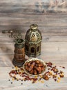 Still life with vintage orintal latern and mill. Raisins and dat Royalty Free Stock Photo