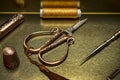A still life with vintage style sewing utensils with copper and with scissors, thimble and spools of prayed thread in a gilt metal Royalty Free Stock Photo