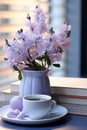 Still life in violet, lilac color. A cup of coffee and a vase of flowers on the table. Royalty Free Stock Photo