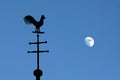 Still life of weathercock and moon in blue sky Royalty Free Stock Photo