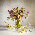 Still life with white daisies and cornflowers. Bouquet meadow flowers in the vase on the wooden table. Elegant romantic image Royalty Free Stock Photo