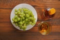 Still life with white juicy grapes, bottle of white wine without any label, and one wine glass. Royalty Free Stock Photo