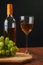 Still life with white juicy grapes, bottle of white wine without any label Royalty Free Stock Photo