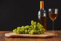 Still life with white juicy grapes, bottle of white wine without any label, Royalty Free Stock Photo