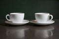 Still life, white kettle and cups on the table