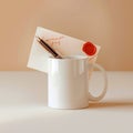 Still life of white mug with letter and pen on table against a peach colored background in soft lighting Royalty Free Stock Photo