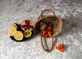still life on a white tablecloth, fruit in a wicker basket and other objects Royalty Free Stock Photo