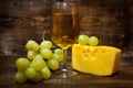 Still life with white wine , cheese and grapes Royalty Free Stock Photo