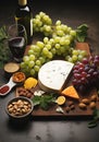 Still life with wine, cheeses and fruits on a dark background. Royalty Free Stock Photo