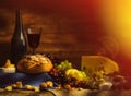 Still life with wine, grapes, bread and various sorts of cheese. Royalty Free Stock Photo