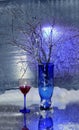 Still life.A winter bouquet. The blue vase. A glass of wine. Snow. Cold. Royalty Free Stock Photo