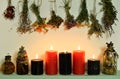 Still life with witch bottles, burning candles and dry flowers and herbs