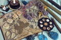Still life with witch diary book and healing herbs drawings, clover, crystals and candles