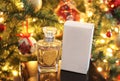 Still life of woman perfume in front of the Christmas tree Royalty Free Stock Photo