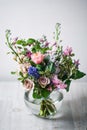 Still life. a wooden antique table, glass vase with Mixed bouquet. beautiful flowers Royalty Free Stock Photo