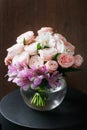 Still life. a wooden antique table, glass vase with Mixed bouquet. beautiful flowers Royalty Free Stock Photo