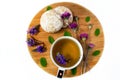 Still life on a wooden board. A cup of herbal tea, biscuits and wildflowers. White background. Royalty Free Stock Photo