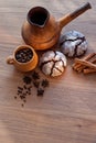 Still life on wooden table with cup, coffee maker, cakes, cinnamon and spices Royalty Free Stock Photo